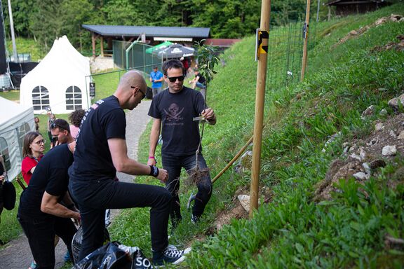 The rock band Zablujena generacija posed alongside their tree in the Rockers' Tree Alley at the Gora Rocka festival in 2023. Author: Marko Čuk