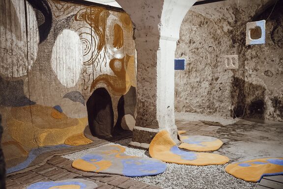 The textile installation The Right to the Sunlight (2023) by Slovenian artist Teja Šter. While creating the artwork in the basement of the Kranj City Hall, the author explored her feelings of light deprivation in her daily workspace during the winter season.