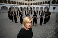 Conductor <!--LINK'" 0:24--> with <!--LINK'" 0:25--> choir in the <!--LINK'" 0:26--> courtyard at Kostanjevica na Krki