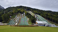 A late summer view of a few of the ski jumping hills in the Nordic Center Planica, the sports objects designed by <!--LINK'" 0:6-->, the landscape architecture <!--LINK'" 0:7-->, 2014.