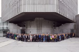A group portrait of Biennial of Design 2019 participants, standing in front of the <!--LINK'" 0:227--> in Ljubljana