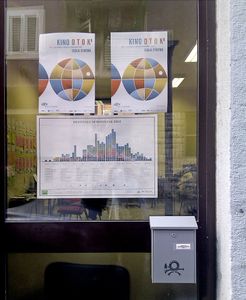 <!--LINK'" 0:143--> infographic calendar next to the <!--LINK'" 0:144--> posters on the festival's office window, 2012