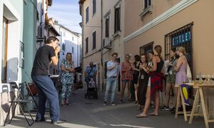 Artist <!--LINK'" 0:1066--> performing in front of Salsaverde gallery at the opening of the festival exhibition of the <!--LINK'" 0:1067-->, <!--LINK'" 0:1068--> 2021.