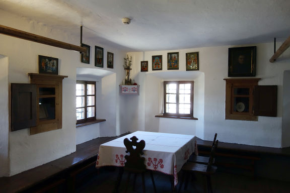 Main living area at Birthplace of France Prešeren, biggest room of the house containing the tiled stove and the benches for older children to sleep on. This table was used only at special occasions, 2013